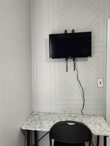 a room with a table and a television on a wall at Close to center in Winnipeg
