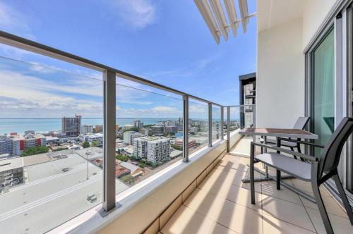a balcony with views of the ocean from a building at Sensation Sunsets Seaviews I Mantra' Central CBD Apartment in Darwin
