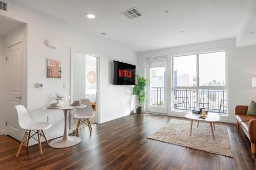 a living room with a couch and a table and chairs at Beautiful 1BR Apt in Hollywood w Pool and Parking in Los Angeles