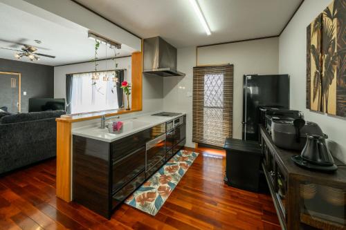 a kitchen with a sink and a counter in a room at Ocean View Terrace BISE 1F in Motobu