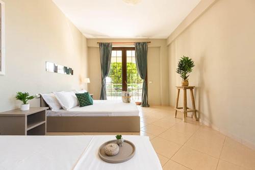 a large room with a bed and a window at Color Villa - South Paradise 7 in Himare