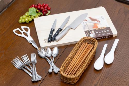 a table with utensils and forks and spoons at アンティークス岐阜駅東 in Gifu