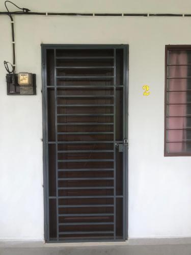 an open door to a white building with a window at Homestay Siti Klang in Klang