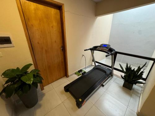 a room with a treadmill next to a door at Casa Privada con Piscina y Parking Gratis en Asunción in Asunción