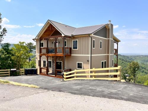 a house on top of a hill with a fence at Luxury 4 BDR, Breathtaking Views, Theater, EVC in Gatlinburg
