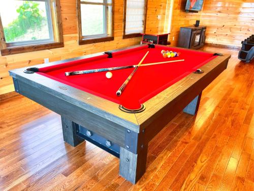 a red pool table with balls on top of it at Luxury 4 BDR, Breathtaking Views, Theater, EVC in Gatlinburg