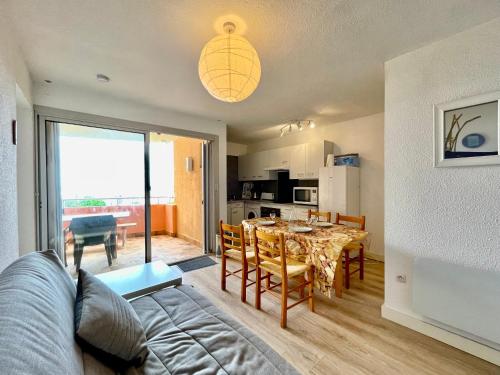 un salon avec une table et une salle à manger dans l'établissement Appartement T3 à Sète face à la mer avec parking privé, proche plage et commerces - FR-1-338-587, à Sète