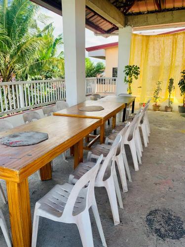 a long wooden table and chairs in a room at Perlies Inn Tanay Barkada House in Tanay