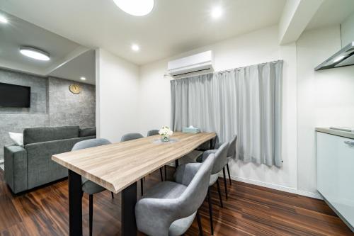 a dining room with a wooden table and chairs at 93, Yotsugi Seven, Entire house for rent, 四つ木セブン in Tokyo