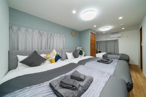a bedroom with two beds with towels on them at 93, Yotsugi Seven, Entire house for rent, 四つ木セブン in Tokyo