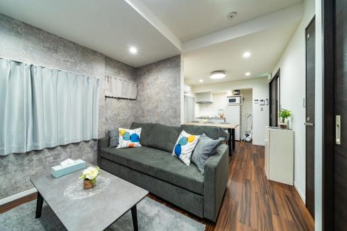 a living room with a couch and a table at 93, Yotsugi Seven, Entire house for rent, 四つ木セブン in Tokyo