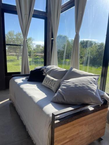 a bed in a room with a large window at Ita Pora Lodge in Bella Vista