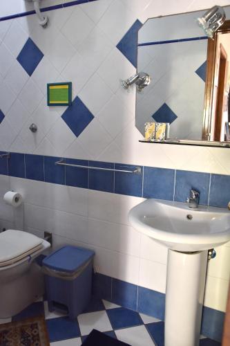 a bathroom with a sink and a toilet and a mirror at Holiday Home Gionny & Mary in Taormina