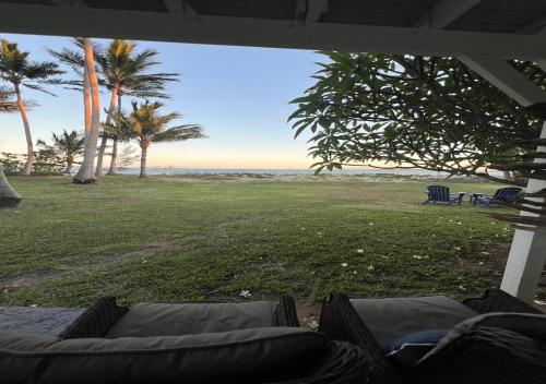 a view of the beach from the porch of a house at Absolute Beachfront Bowen Beach House 3 Bedroom in Bowen