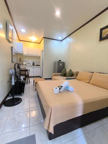 a large room with two beds and a kitchen at South Breeze Balibago 3 minutes away from Santa Rosa Commercial Complex in Macabling