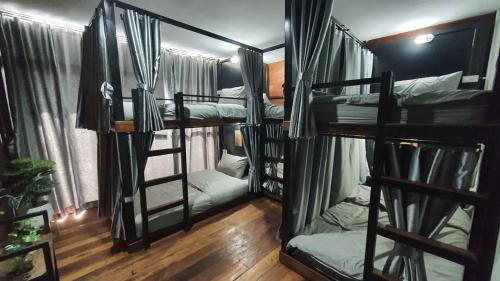 a group of four bunk beds in a room at Pai My Way Hostel in Pai