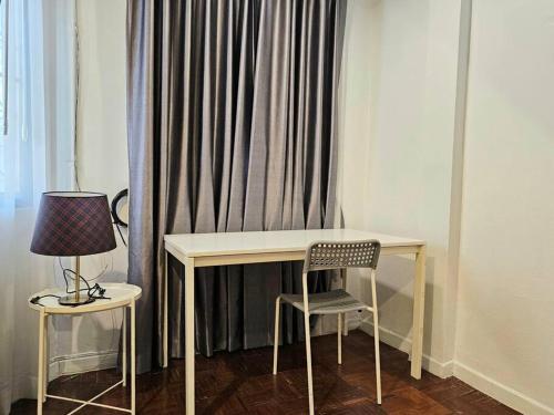 a desk with a chair and a lamp next to a curtain at 10mins BTS Skytrain Onnut station in Amphoe Phra Khanong