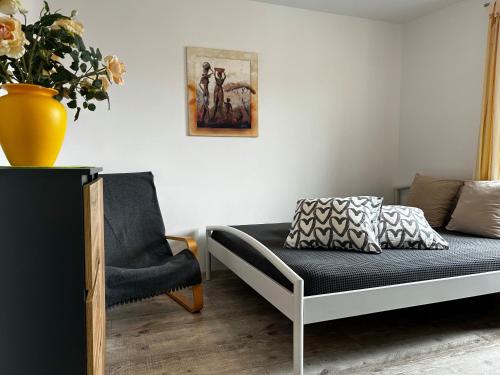 a living room with a couch and a chair at Apartamenty i Pokoje Tornado in Krynica Morska