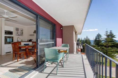 a patio with a table and chairs on a balcony at Cottesloe Seaside Bliss in Perth