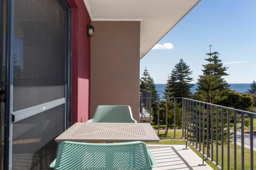 a balcony with a table and two chairs at Cottesloe Seaside Bliss in Perth