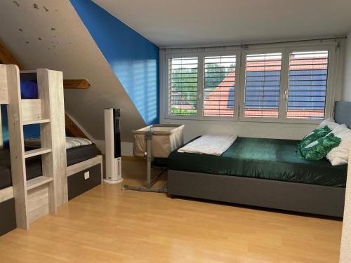 a bedroom with a bunk bed and a ladder at Winner Star RVSVN Ferien Wohnung in Safenwil