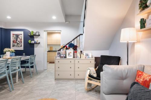 a living room with a couch and chairs and a table at Spacious 4BRTownhouse BTS Onnut 10 Sleeps with Parking in Amphoe Phra Khanong