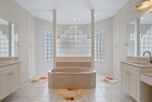 a large bathroom with a tub and a sink at Mins To Florida White Sand Beach Villa Heated Pool in Nokomis