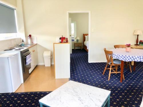 a kitchen and dining room with a table and a table and chairs at Douglas Riverside in Port Fairy