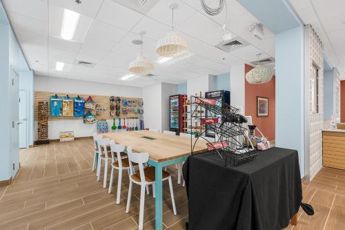 a dining room with a table and chairs at Golden Sands Carolina Beach Oceanfront, Tapestry by Hilton in Carolina Beach