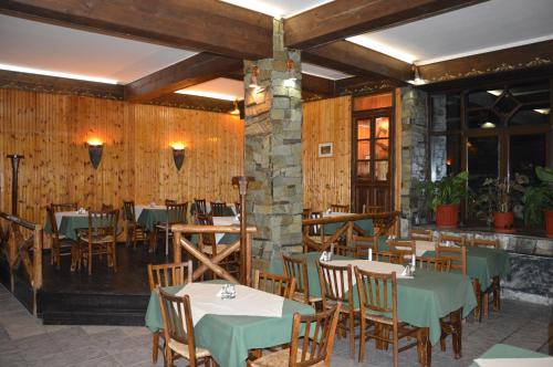 a restaurant with tables and chairs in a room at Hotel Hani Zisi in Chania