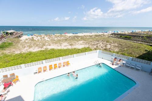 an overhead view of a swimming pool and the beach at Golden Sands Carolina Beach Oceanfront, Tapestry by Hilton in Carolina Beach
