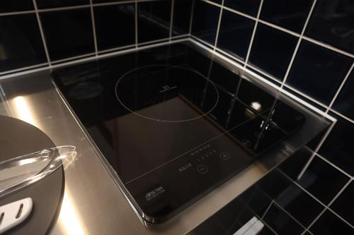 a cell phone sitting on top of a counter at まほろの宿 - 明日香村のリノベーション古民家一棟貸し in Asuka