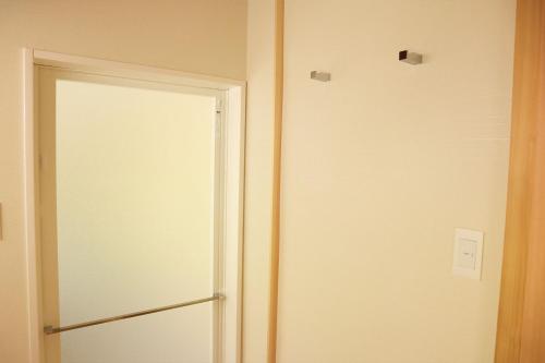 an open door in a room with a door at まほろの宿 - 明日香村のリノベーション古民家一棟貸し in Asuka