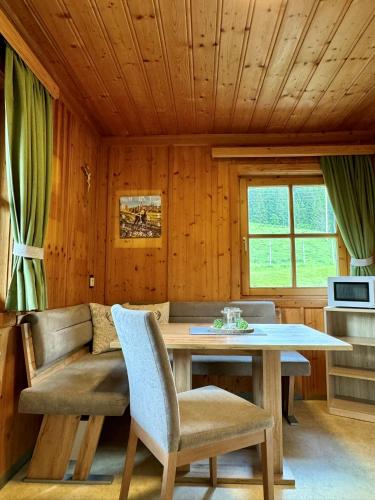 a dining room with a table and chairs at Hallmoosgut in Sankt Johann im Pongau
