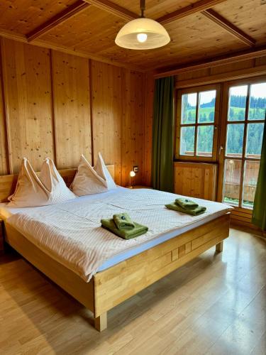 a bedroom with a bed with two green towels on it at Hallmoosgut in Sankt Johann im Pongau