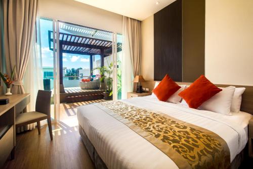 a bedroom with a large bed and a large window at Krabi Luxury Penthouse in Klong Muang Beach