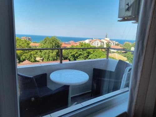 a view of a balcony with a table and chairs at Крин in Sinemorets