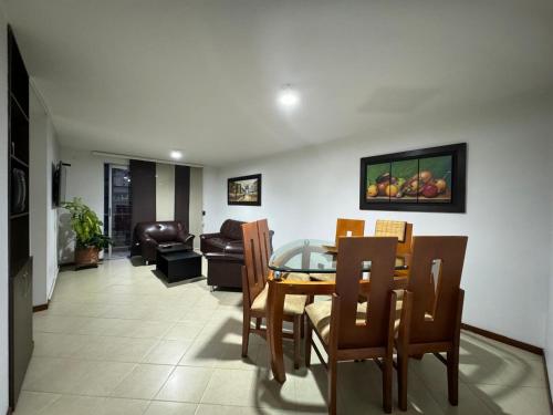 a dining room and living room with a table and chairs at MARGARETH in Manizales