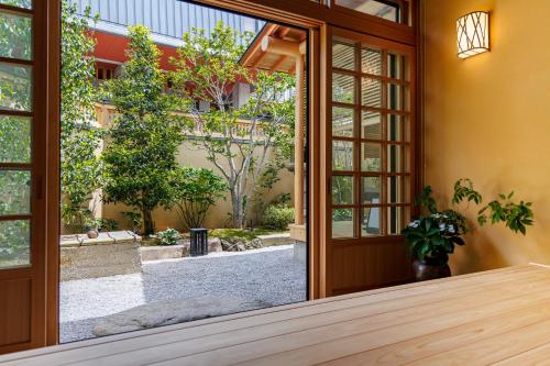 a sliding glass door with a view of a courtyard at Shoraiso in Yamanouchi