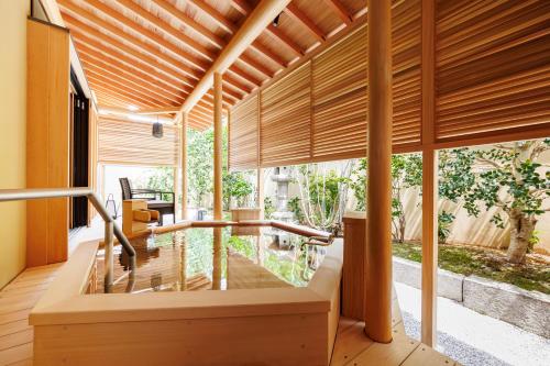 a living room with wooden blinds on a house at Shoraiso in Yamanouchi