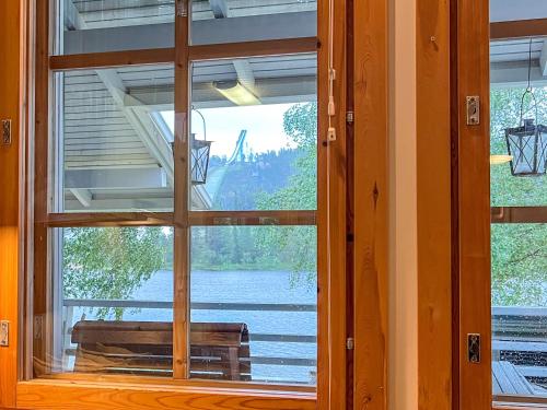 a window in a room with a view of a lake at Lomakivakka - Roomy 2BD & loft by the lake, free wifi and sauna in Ruka