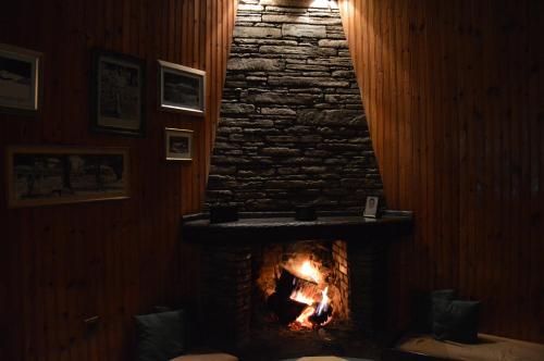 a fireplace in a room with a brick wall at Hotel Hani Zisi in Chania