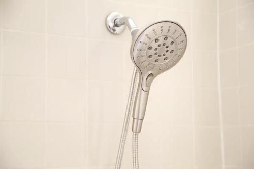a shower head is attached to a wall at Chic 4BR Dwelling with Backyard in Philadelphia in Philadelphia