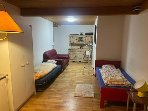 a room with two beds and a living room at Meiringen holiday in Meiringen