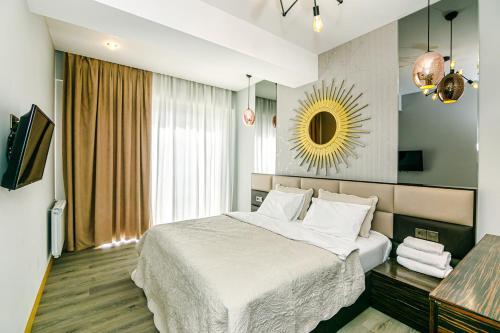 a hotel room with a bed and a mirror at Park Azure Deluxe Home 526 in Baku