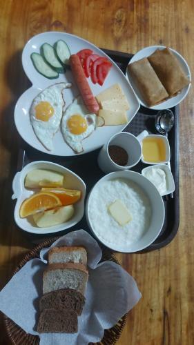 een dienblad met ontbijtproducten op een tafel bij KAIER Hotel in Alma-Ata