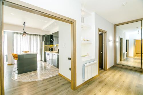 a kitchen and living room with a large sliding glass door at Park Azure Deluxe Home 526 in Baku