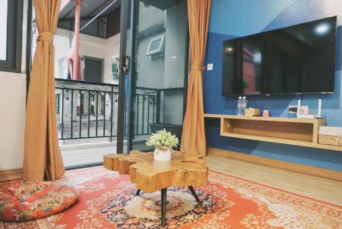 a living room with a table and a tv at The Shilla Apartment in Hanoi