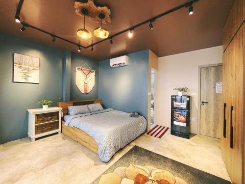 a bedroom with a bed and a refrigerator in it at The Shilla Apartment in Hanoi