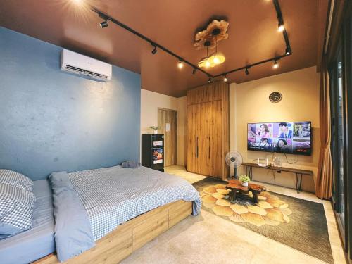 a bedroom with a bed and a flat screen tv at The Shilla Apartment in Hanoi